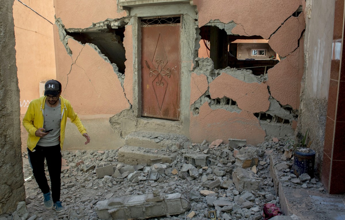 epa10850165 A person walks over debris next to a damaged building following an earthquake in Marrakesh, Morocco, 09 September 2023. A powerful earthquake that hit central Morocco late 08 September, ki ...