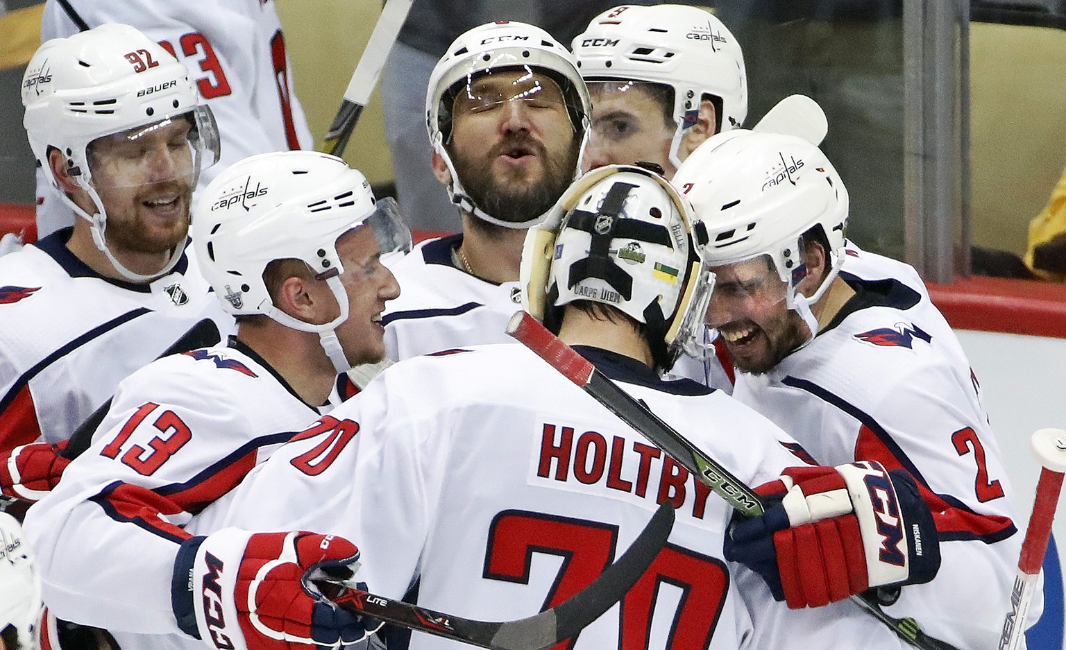 Washington Capitals goaltender Braden Holtby (70) celebrates with Evgeny Kuznetsov (92), Jakub Vrana (13), Alex Ovechkin, top center, and Matt Niskanen (2) after Kuznetsovs&#039; game-winning goal dur ...