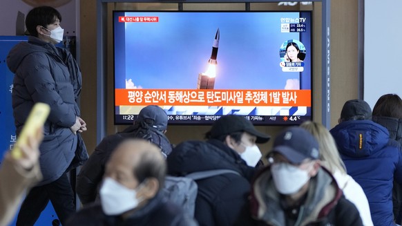 People watch a TV showing a file image of North Korea&#039;s missile launch during a news program at the Seoul Railway Station in Seoul, South Korea, Saturday, March 5, 2022. North Korea on Saturday f ...