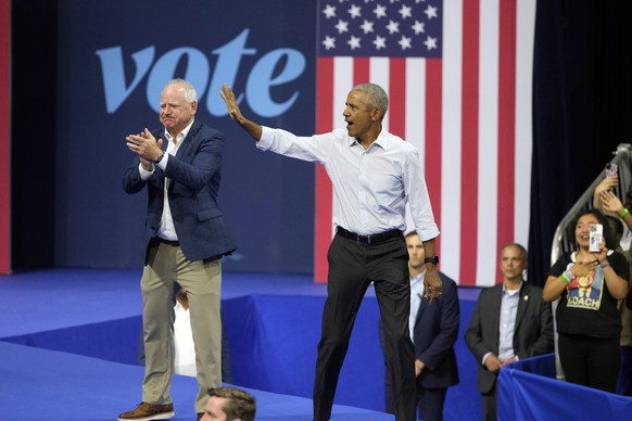 Democratic vice presidential nominee Minnesota Gov. Tim Walz, left, and former President Barack Obama wave at a campaign event Tuesday, Oct. 22, 2024, in Madison, Wis. (AP Photo/Morry Gash)