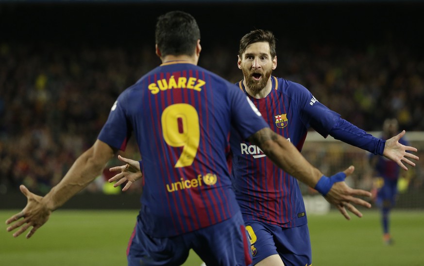 FILE - In this May 6, 2018 file photo Barcelona&#039;s Lionel Messi, rear, celebrates with Barcelona&#039;s Luis Suarez after scoring his side&#039;s second goal during a Spanish La Liga soccer match  ...