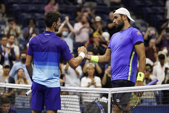 Novak Djokovic, left, of Serbia, shakes hands with Matteo Berrettini, of Italy, after Djokovic&#039;s win during the quarterfinals of the U.S. Open tennis tournament Thursday, Sept. 9, 2021, in New Yo ...
