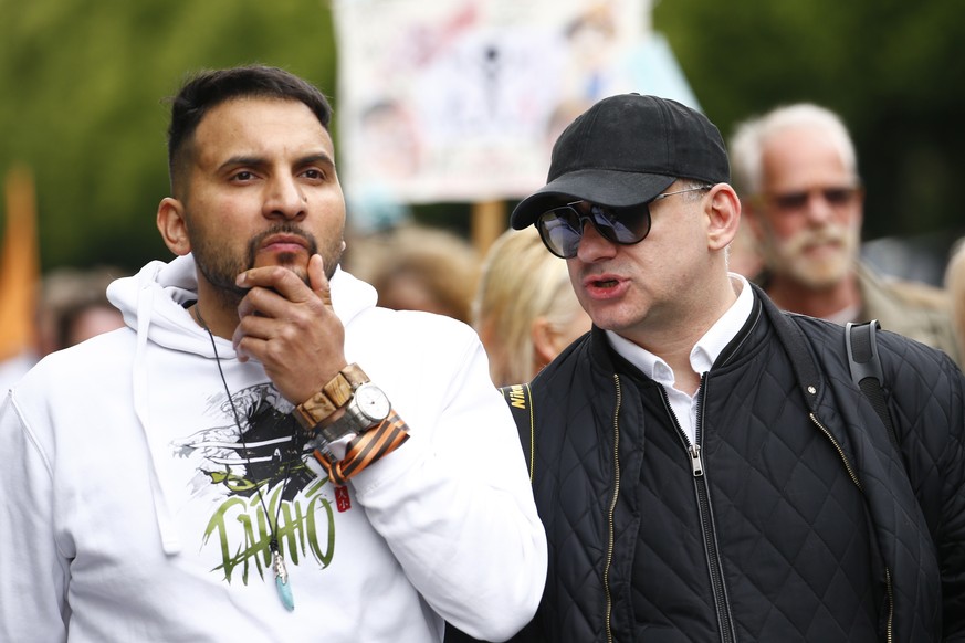 epa08454706 Protesters lead by Attila Hildmann (L) during an anti-restrictions demonstration in Berlin, Germany, 30 May 2020. A series of demonstrations throughout the German capital, calling for endi ...