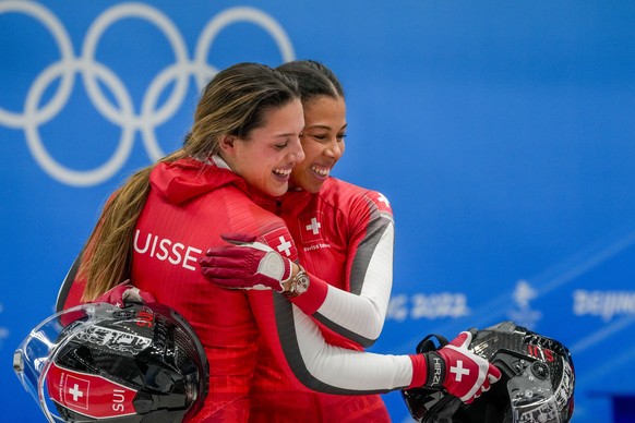Melanie Hasler and Nadja Pasternack, of Switzerland, celebrate after the women's bobsleigh heat 4 at the 2022 Winter Olympics, Saturday, Feb. 19, 2022, in the Yanqing district of Beijing. (AP Photo/Dmitri Lovetsky)