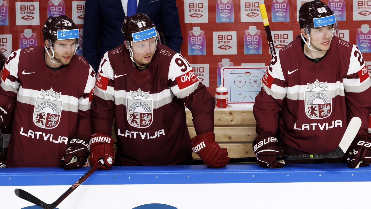 Latvia's forward Deniss Smirnovs #73, Latvia's forward Ronalds Kenins #91 and Latvia's forward Toms Andersons #22, look their teammates, during the IIHF 2023 World Championship prelimin ...