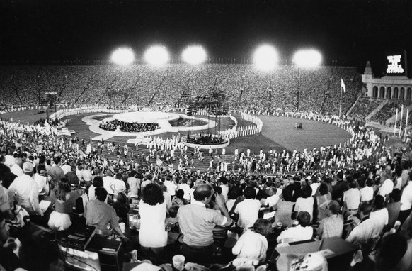 The Memorial Coliseum of Los Angeles is filled to capacity as the athletes who competed in the Olympic Games parade on the track for the closing ceremonies, Aug. 12, 1984. (AP Photo/Lionel Cironneau)