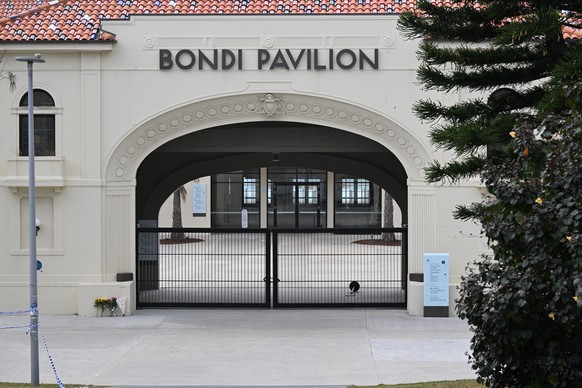 epa12592772 Flowers are laid outside the Bondi Pavilion, the scene where two gunmen opened fire at Bondi Beach in Sydney, Australia, 15 December 2025. Australia is in mourning after gunmen opened fire ...