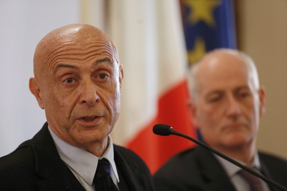 Italian Interior Minister Marco Minniti (L) and cheif of police Franco Gabrielli attend a news conference in Rome, Italy, to announce that the suspect in the Berlin truck attack was killed in a shoot- ...