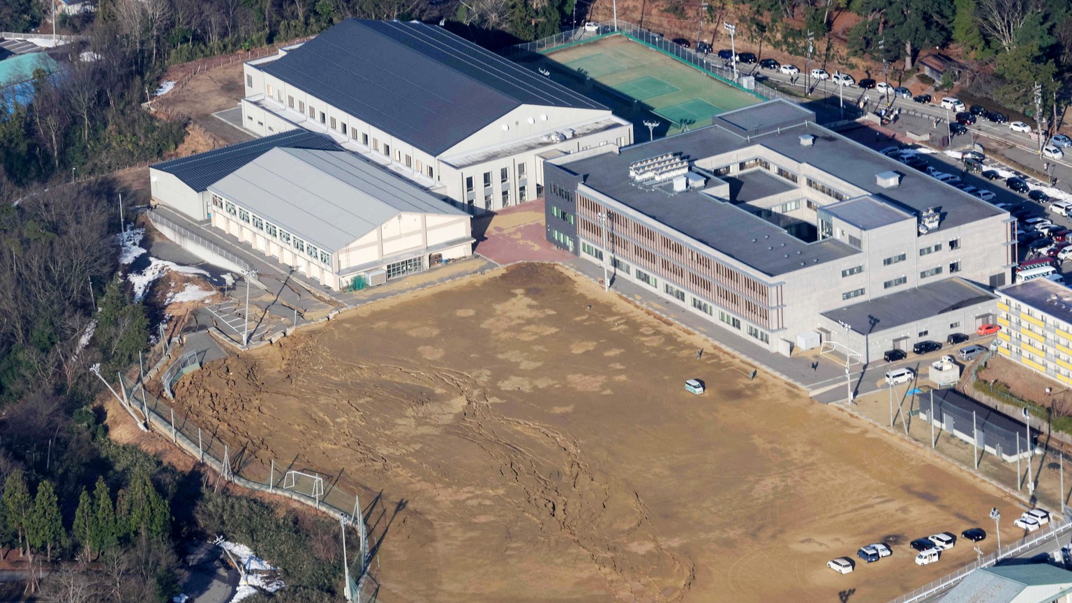 epa11052998 An aerial view shows damage at Wajima junior high school from a strong earthquake, in Wajima, central Japan, 02 January 2024. The Ishikawa Prefecture Government as well as the Fire and Dis ...