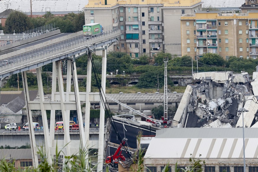 Cars are blocked on the Morandi highway bridge after a section of it collapsed, in Genoa, northern Italy, Tuesday, Aug. 14, 2018. A large section of the bridge collapsed over an industrial area in the ...