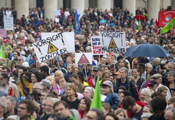 epa06904477 Protestors hold up banners reading &#039;Caution Igniter&#039; and &#039;Caution wall builder&#039; during a demonstration against right-wing politics and what they say was anti-democracy  ...