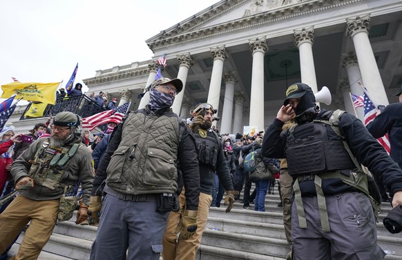 FILE - Members of the Oath Keepers extremist group stand on the East Front of the U.S. Capitol on Jan. 6, 2021, in Washington. The Capitol riot was the culmination of weeks of preparation and a moment ...