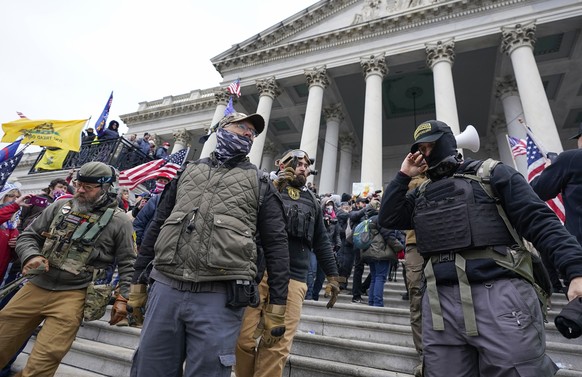 TILE - Members of the extremist group Oath Keepers stand on the eastern front of the US Capitol in Washington on January 6, 2021.  The riot in the Capitol was the culmination of weeks of preparation and a moment...