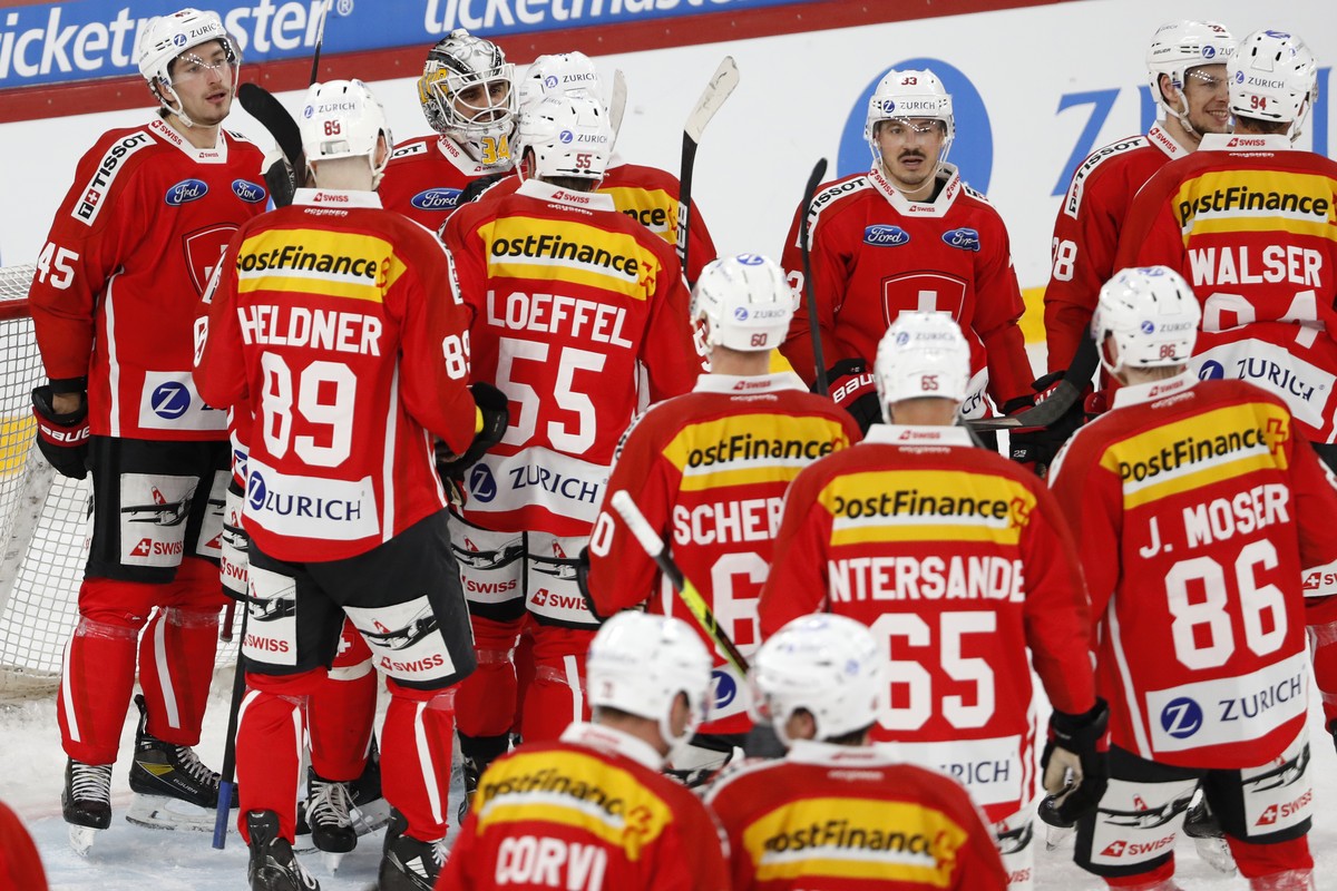 Switzerland's goalkeeper Niklas Schlegel, center back, celebrates with his teammates at the end of a friendly ice hockey match between Switzerland and Russia, at the Tissot Arena in Biel, Switzer ...