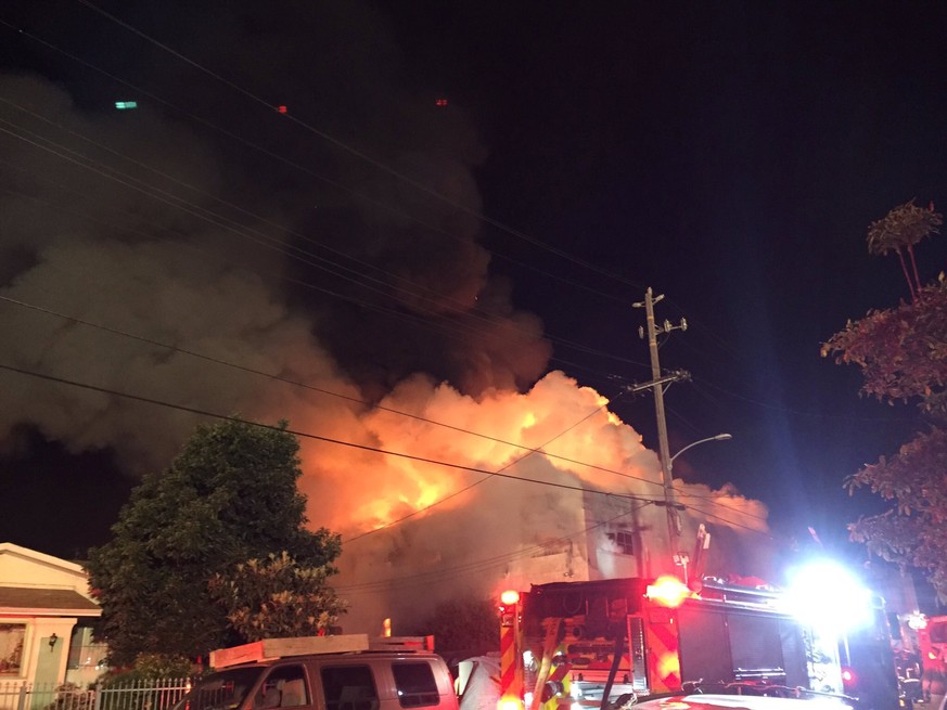 Flames rise from the top of a warehouse, which caught fire during a dance party in Oakland, California,U.S. December 3, 2016. Seung Lee/Handout via Reuters ATTENTION EDITORS - THIS IMAGE WAS PROVIDED  ...