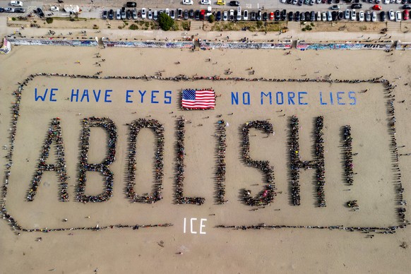 KEYPIX - In an aerial view, protesters form a human banner on Ocean Beach during a protest amidst the ongoing nationwide federal immigration raids and unrest in Minneapolis, in San Francisco, Saturday ...