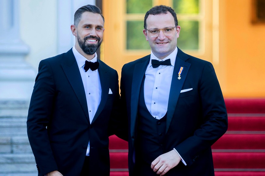 FILE - The then-German Health Minister Jens Spahn, right, and his husband Daniel Funke, left, arrive at Bellevue presidential palace to attend a State banquet hosted by the Federal President and his w ...