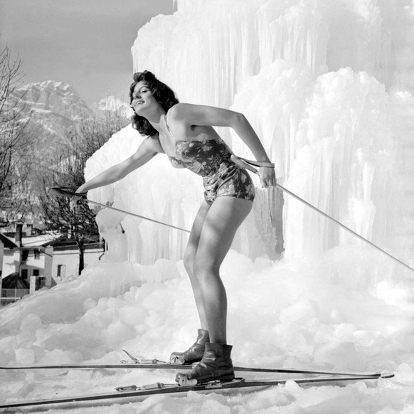 Winter Olympic Games held at Cortina d' Ampezzo in Northern Italy. Model in swimwear posing with skis on the ice. January 1956. (Photo by Mirrorpix via Getty Images)