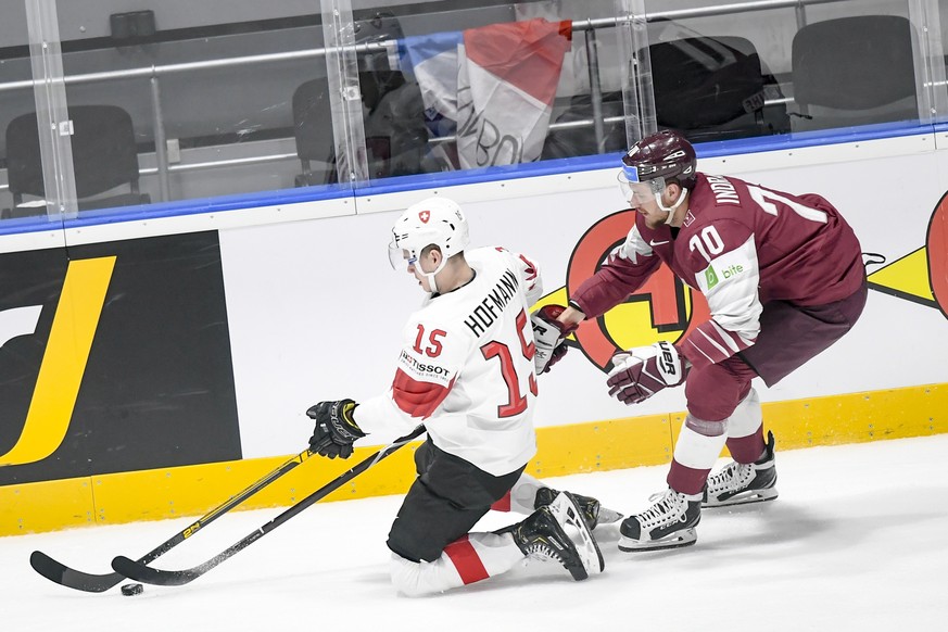 epa07565545 Gregory Hofmann of Switzerland (L) in action against Miks Indrasis of Latvia (R) during the IIHF World Championship group B ice hockey match between Latvia and Switzerland at the Ondrej Ne ...