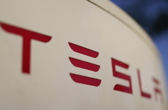 FILE - The logo for the Tesla Supercharger station is seen in Buford, Ga, April 22, 2021,. Tesla is recalling nearly 579,000 vehicles in the U.S. because sounds played over an external speaker can obs ...