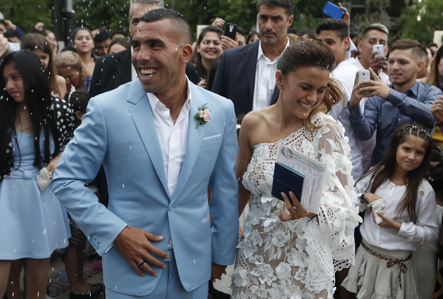 Soccer star Carlos Tevez and his wife Vanesa Mansilla exit the church after getting married in in Buenos Aires, Argentina, Thursday, Dec. 22, 2016. (AP Photo/Luciano Matteazzi)