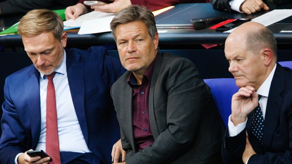 epa11662251 German Chancellor Olaf Scholz (R), German Minister for Economy and Climate Robert Habeck (C) and German Finance Minister Christian Lindner (L) follow the speech of Chairman of the Christia ...