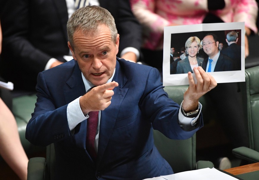 QUESTION TIME, Leader of the Opposition Bill Shorten holds a photograph of Minister for Foreign Affairs Julie Bishop and chinese businessman Huang Xiangmo during Question Time in the House of Represen ...