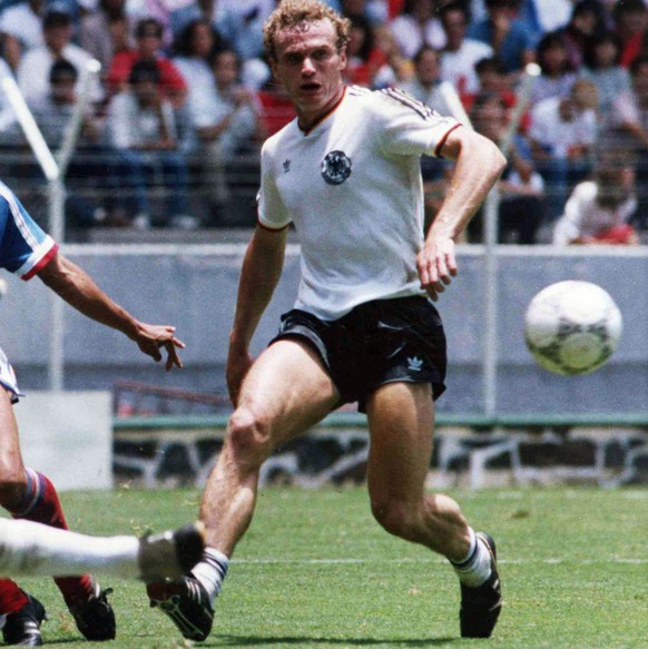 German goalkeeper Harald Schumacher, left, and defender Hans-Peter Briegel, right, stop France&#039;s William Ayache during the Football World Cup Semi-Final in Guadalajara, Mexico, on June 25, 1986.  ...