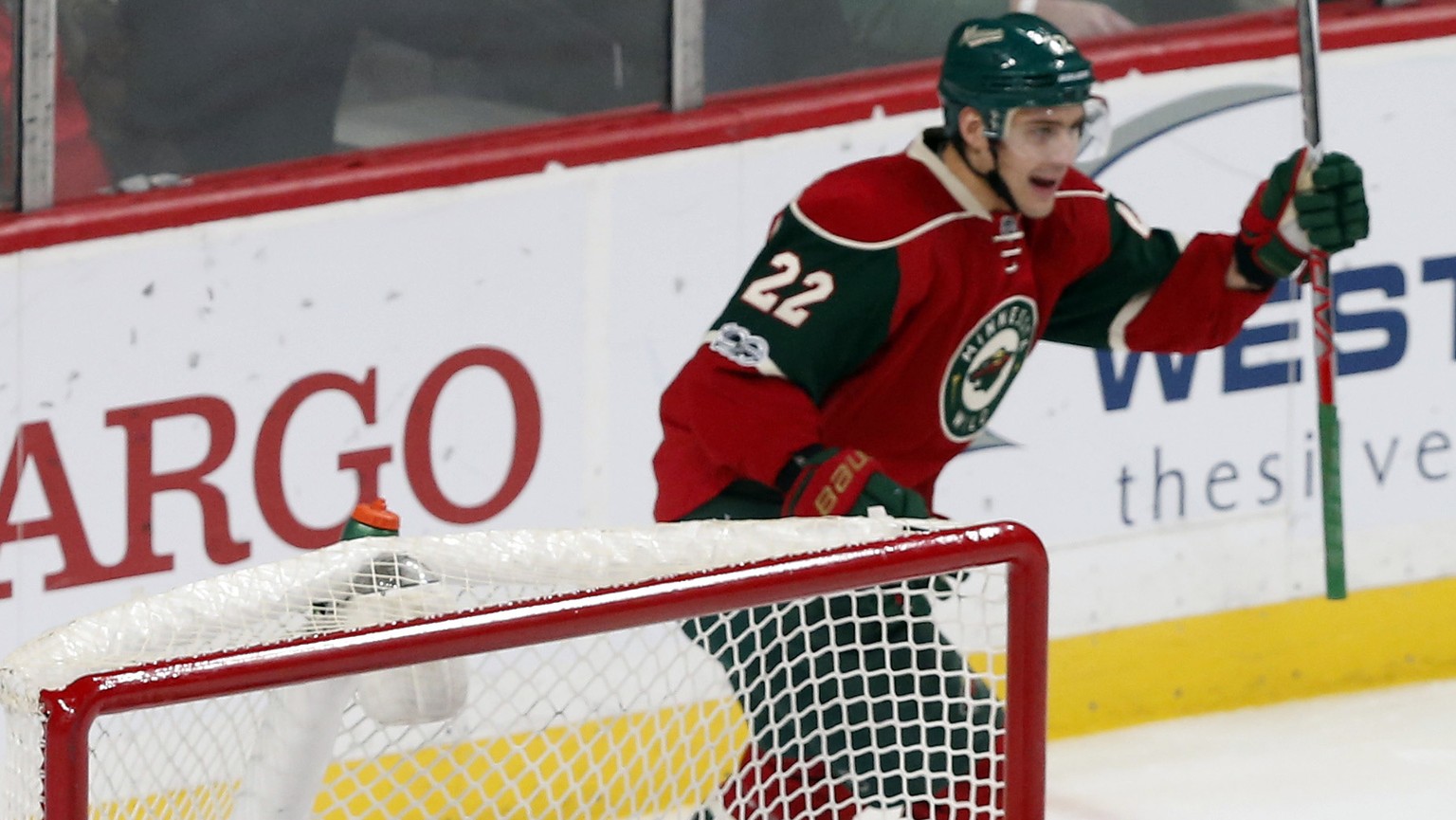 Minnesota Wild&#039;s Nino Niederreiter, top, of Switzerland, celebrates a goal by Zach Parise off Carolina Hurricanes goalie Cam Ward, lower right, in the first period of an NHL hockey game Tuesday,  ...