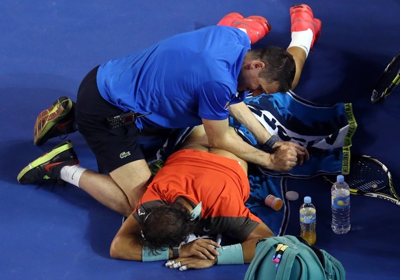 Rafael Nadal of Spain receives a medical treatment to his back during the men&#039;s singles final against Stanislas Wawrinka of Switzerland at the Australian Open tennis championship in Melbourne, Au ...
