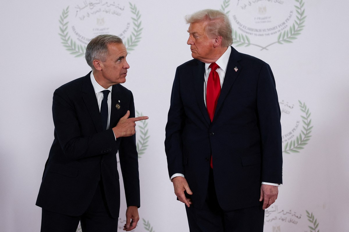 President Donald Trump and Canadian Prime Minister Mark Carney, left, speak as they pose for a photo at a world leaders' summit on ending the Gaza war, in Sharm el-Sheikh, Egypt, Monday, Oct. 13, ...