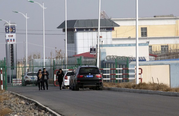 FILE - In this Dec. 3, 2018, file photo, people walk by a police station by the front gate of the Artux City Vocational Skills Education Training Service Center in Artux in western China&#039;s Xinjia ...