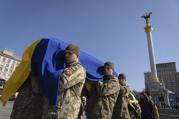 Soldiers carry the coffin of volunteer soldier Bizhan Sharopov, a PhD neurobiologist and professor at Kyiv-Mohyla Academy, killed in combat with Russian troops near Bakhmut, during a farewell...