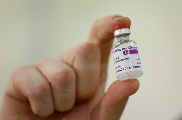 FILE - In this Jan. 2, 2021 file photo a vial of the COVID-19 vaccine developed by Oxford University and U.K.-based drugmaker AstraZeneca is checked as they arrive at the Princess Royal Hospital in Haywards Heath, England. The European Medicines Agency is expected on Friday Jan. 29, 2021 to authorize use of the vaccine AstraZeneca developed with Oxford University. It would be the third cleared for use in the EU, after the BioNTech-Pfizer and Moderna vaccines. (Gareth Fuller/Pool via AP, File)