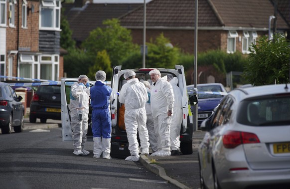 Forensic officers near the scene in Kingsheath Avenue, Knotty Ash, where a nine-year-old girl was fatally shot, in Liverpool, England, Tuesday, Aug. 23, 2022. Officers from Merseyside Police have star ...