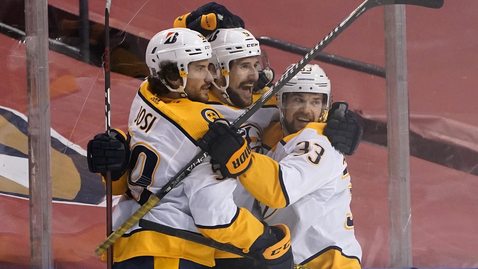 Nashville Predators defenseman Roman Josi (59) and right wing Viktor Arvidsson (33) celebrate with left wing Filip Forsberg, center, after Forsberg scored the winning goal during an overtime period of ...