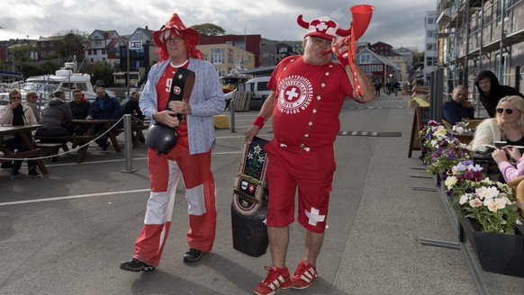 Tow Swiss fans with cowbells parade through Torshavn, Faroe Islands, on Thursday, June 8, 2017. Switzerland is scheduled to play a 2018 Fifa World Cup Russia group B qualification soccer match against ...