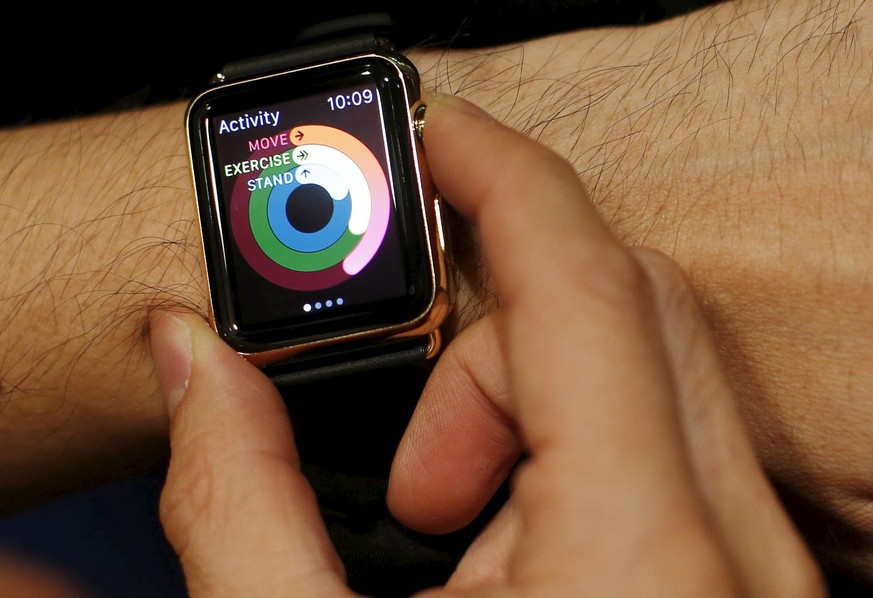 Customer Chai Yeewei tries on an Apple Watch Edition collection watch at a luxury watch boutique in Singapore June 26, 2015. The Apple Watch Edition, which features 18-carat gold watch cases, retails  ...