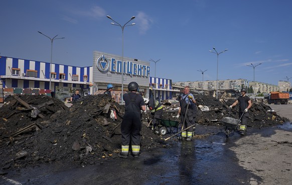 epa11371743 Communal workers clear debris following yesterday&#039;s shelling of the hypermarket in Kharkiv, Ukraine, 26 May 2024 amid the Russian invasion. Russian troops shelled by two glide-bombs t ...