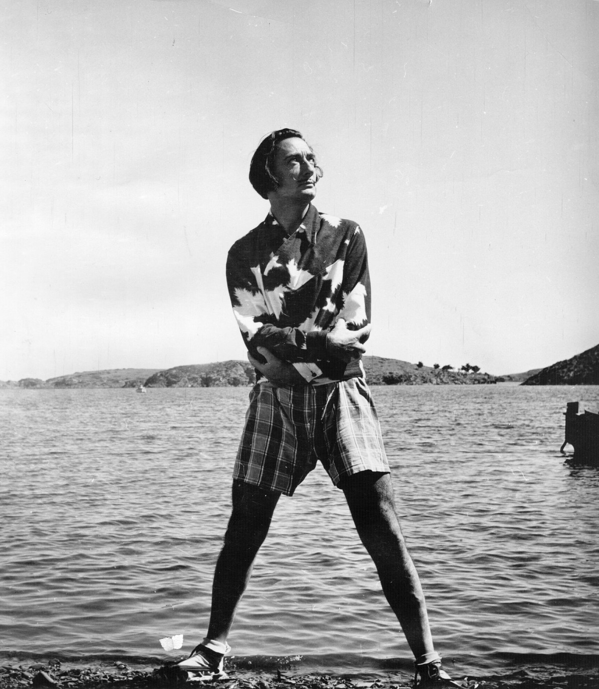 Spanish surrealist artist Salvador Dali (1904 - 1989) on the beach outside his villa at Port Lligat near Cadaques on the Spanish coast. Original Publication: Picture Post - 5587 - We Visit Dali - pub. ...