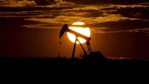 FILE - The sun sets behind an idle pump jack near Karnes City, USA, April 8, 2020. Oil prices are sagging amid fears of recessions across the globe. OPEC and allied countries are weighing what to do a ...