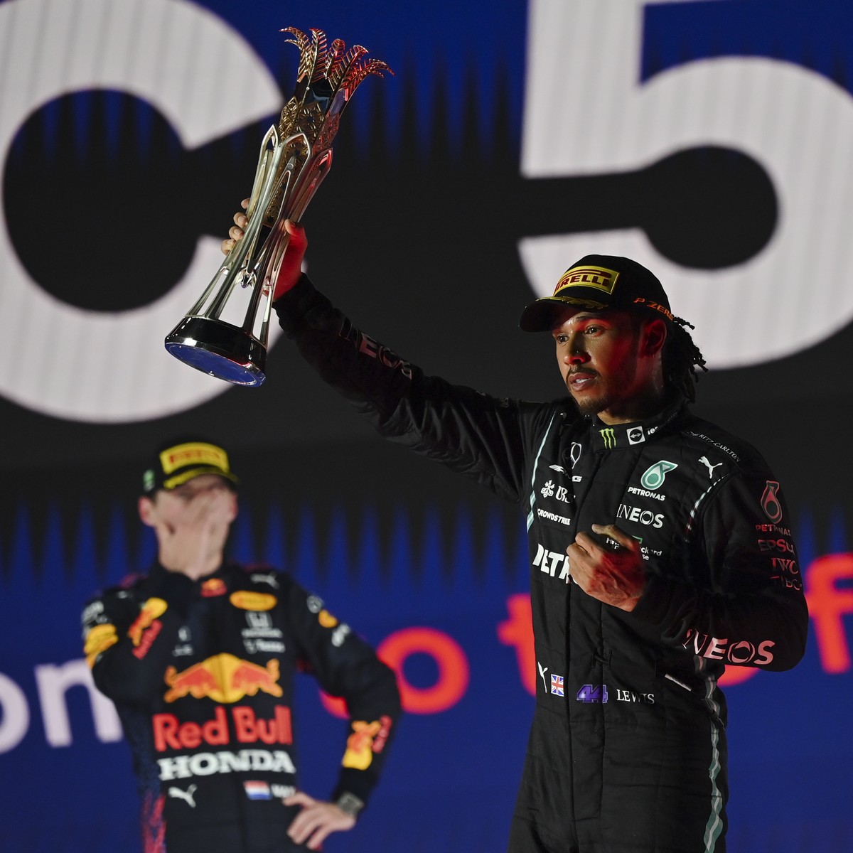 epa09624630 Winner British Formula One driver Lewis Hamilton (R) of Mercedes-AMG Petronas and second placed Dutch Formula One driver Max Verstappen (L) of Red Bull Racing react on the podium after the ...