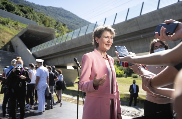 epa08644105 Swiss Federal President Simonetta Sommaruga (C), speaks to the press, one day ahead of the inauguration of the 15.4-kilometres long base railway tunnel under the Monte Ceneri in the canton ...