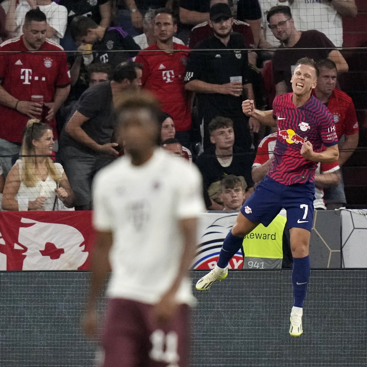 Leipzig's Dani Olmo celebrates after scoring his sides third goal during the German Super Cup final between FC Bayern Munich and RB Leipzig at the Allianz Arena stadium in Munich, Germany, Saturd ...
