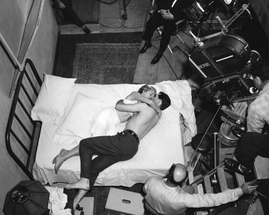 4. Janet Leigh and John Gavin doing a scene for the film Psycho (1960). Director Alfred Hitchcock is in the chair at the top of the picture. 

http://www.newsmov.biz/hitchcock-psycho-set.html