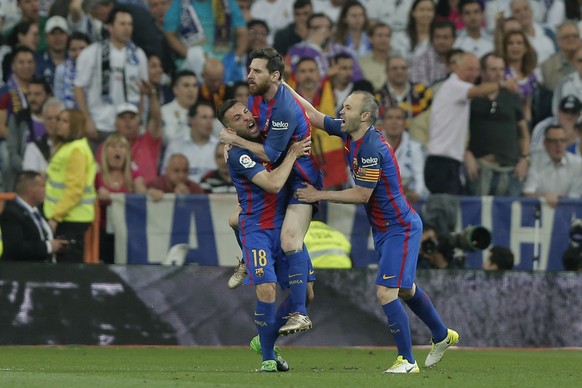 Barcelona&#039;s Lionel Messi, center, celebrates with Jordi Alba and Andres Iniesta, right after scoring his side&#039;s 1st goal during a Spanish La Liga soccer match between Real Madrid and Barcelo ...