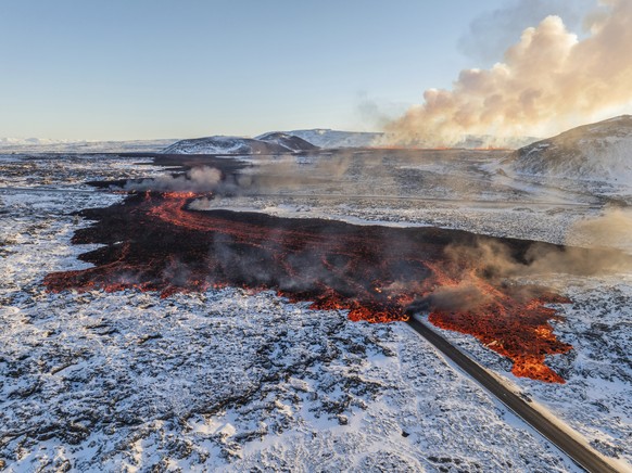 A view of lava crossing the main road to Grindav�k and flowing on the road leading to the Blue Lagoon, in Grindav�k, Iceland, Thursday, Feb. 8, 2024. A volcano triggered the evacuation of the Blue Lag ...
