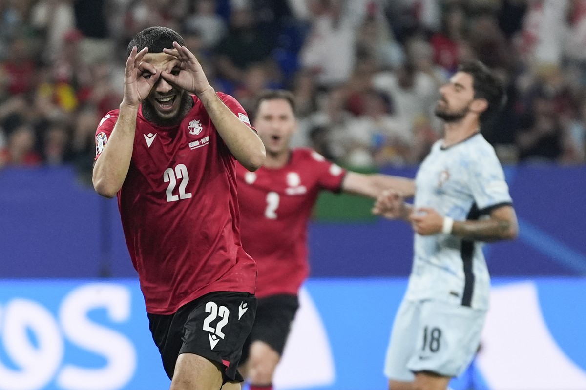 Georgia's Georges Mikautadze celebrates after scoring on a penalty kick during a Group F match between Georgia and Portugal at the Euro 2024 soccer tournament in Gelsenkirchen, Germany, Wednesday ...