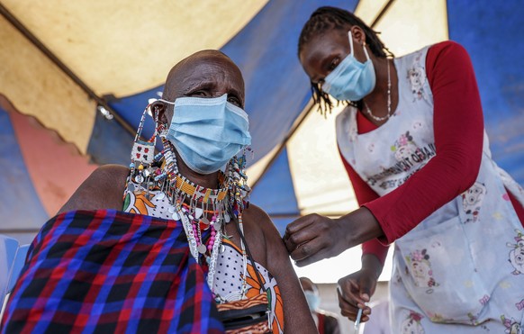 FILE - A Maasai woman receives the AstraZeneca coronavirus vaccine at a clinic in Kimana, southern Kenya on Aug. 28, 2021. The World Health Organization said Thursday, April 14, 2022 that the number o ...