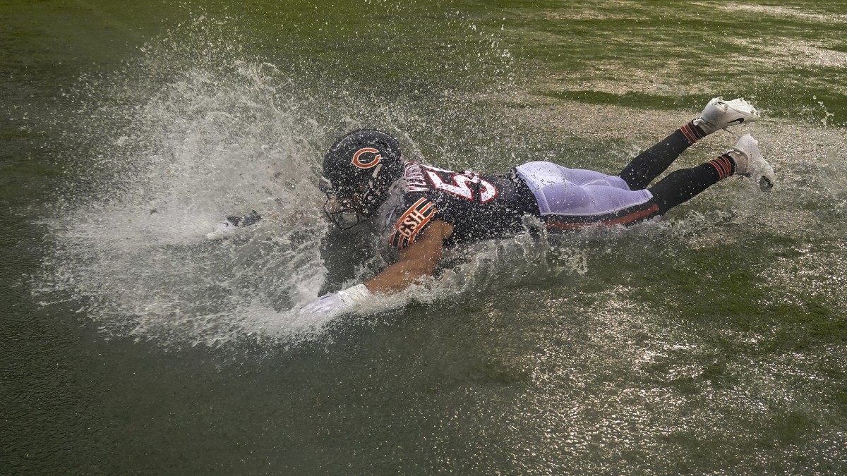 Chicago Bears' Sterling Weatherford celebrates by sliding in a puddle after an NFL football game against the San Francisco 49ers Sunday, Sept. 11, 2022, in Chicago. The Bears won 19-10. (AP Photo ...
